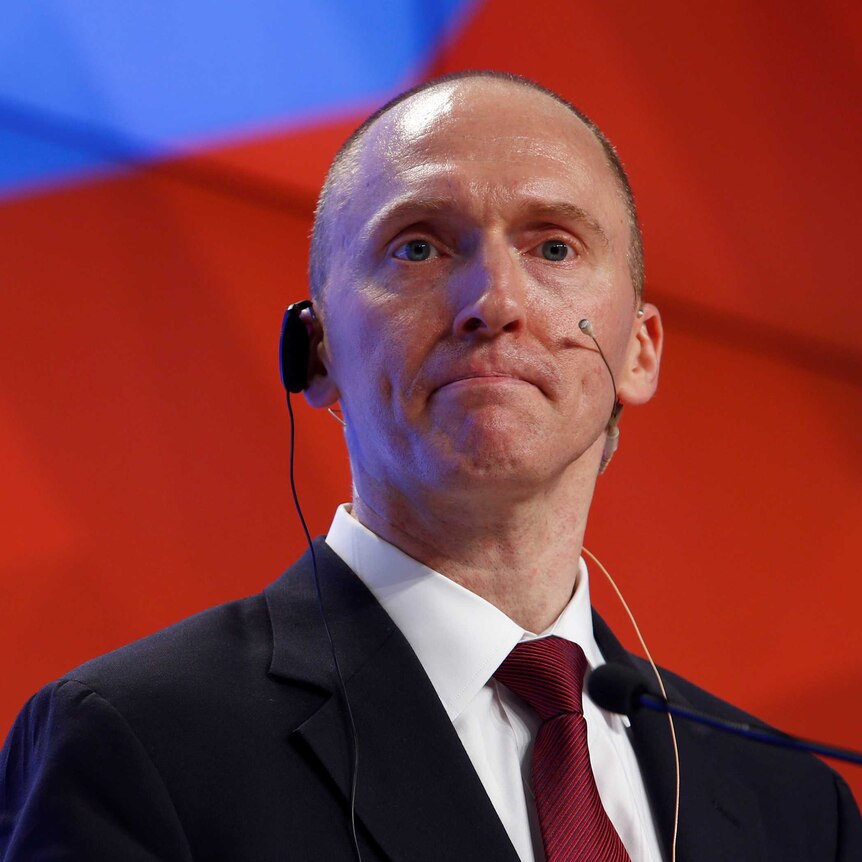 Carter Page has a microphone hooked up to his ear during a presentation in Moscow.