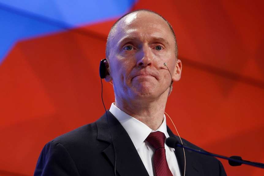 Carter Page has a microphone hooked up to his ear during a presentation in Moscow.