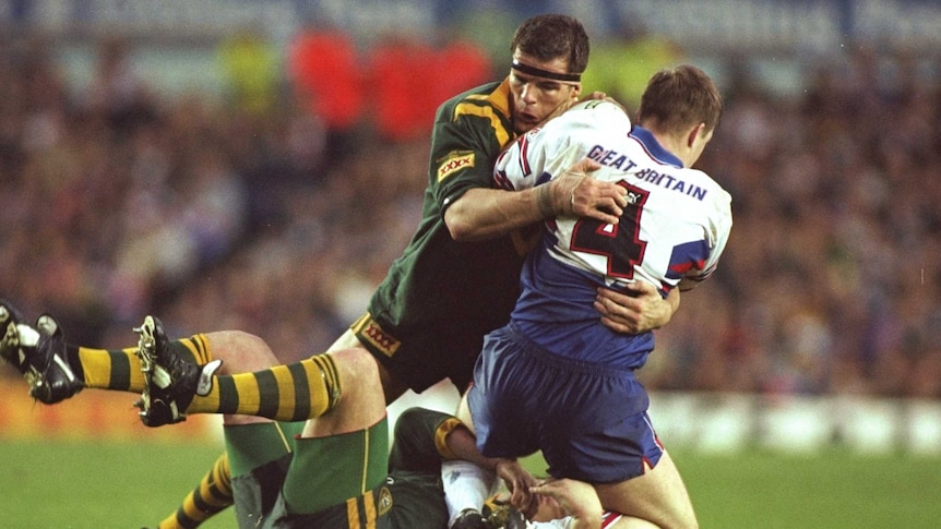 Ian Roberts in green and gold rep uniform tacking Paul Newlove of Great Britain