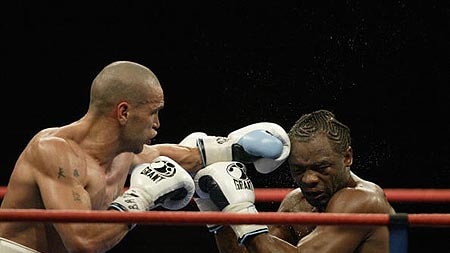Anthoy Mundine inflicts a blow upon Antwun Echols.