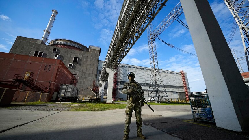 A Russian stands guard at the Zaporizhzhia nuclear plant in southern Ukraine