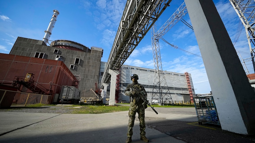 A Russian stands guard at the Zaporizhzhia nuclear plant in southern Ukraine