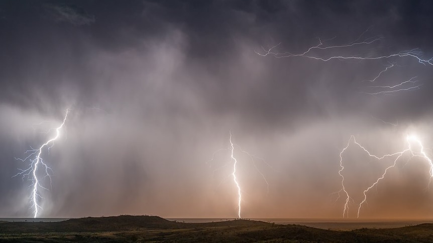 A wide shot of lightning and a storm 