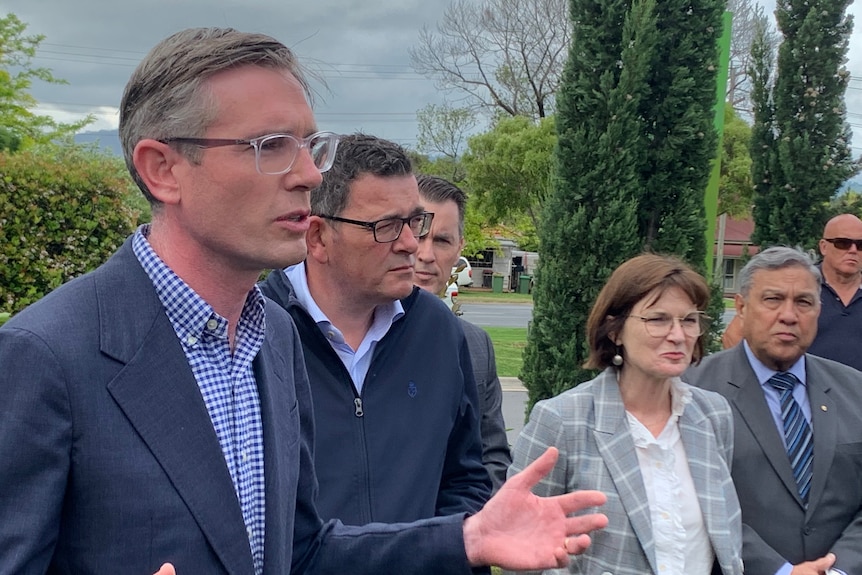 Dominic Perottet addresses the media flanked by Daniel Andrews.