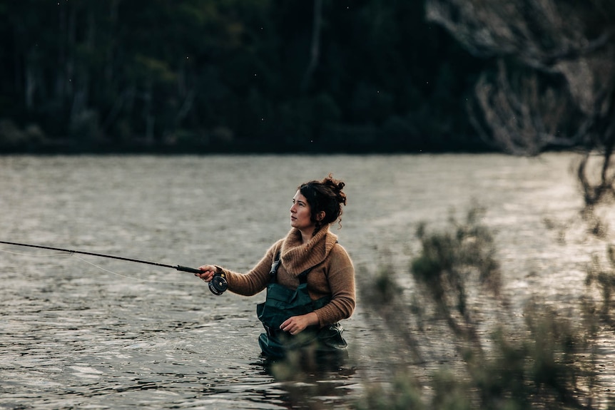 Woman fishing in waders 