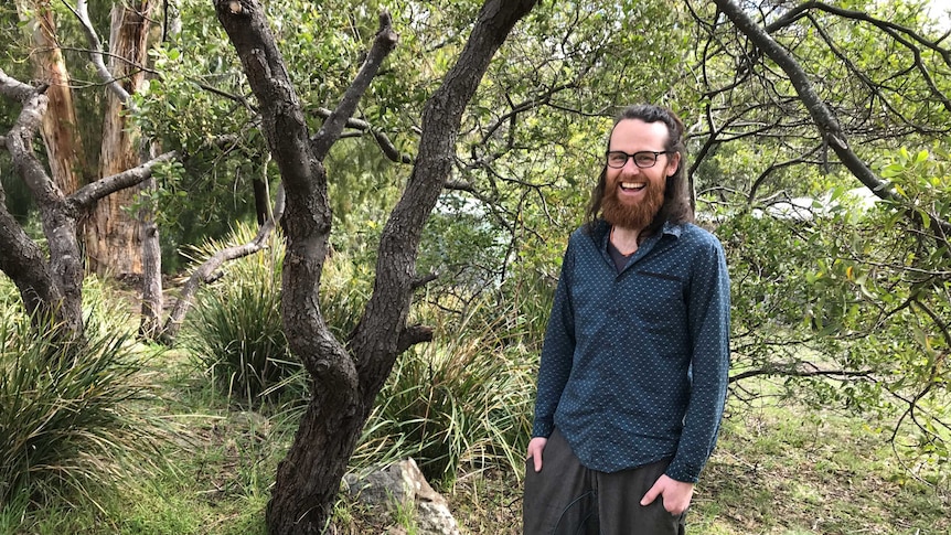 Sound artist Ashley Bartholomew beneath a tree in his garden