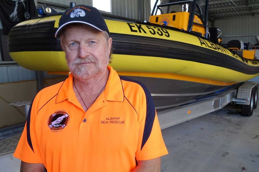 Chris Johns standing in front of boat