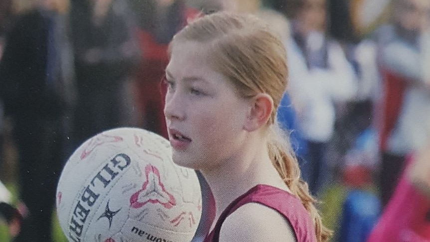 Chloe Myors holding a netball.