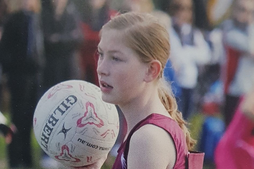 Chloe Myors holding a netball.