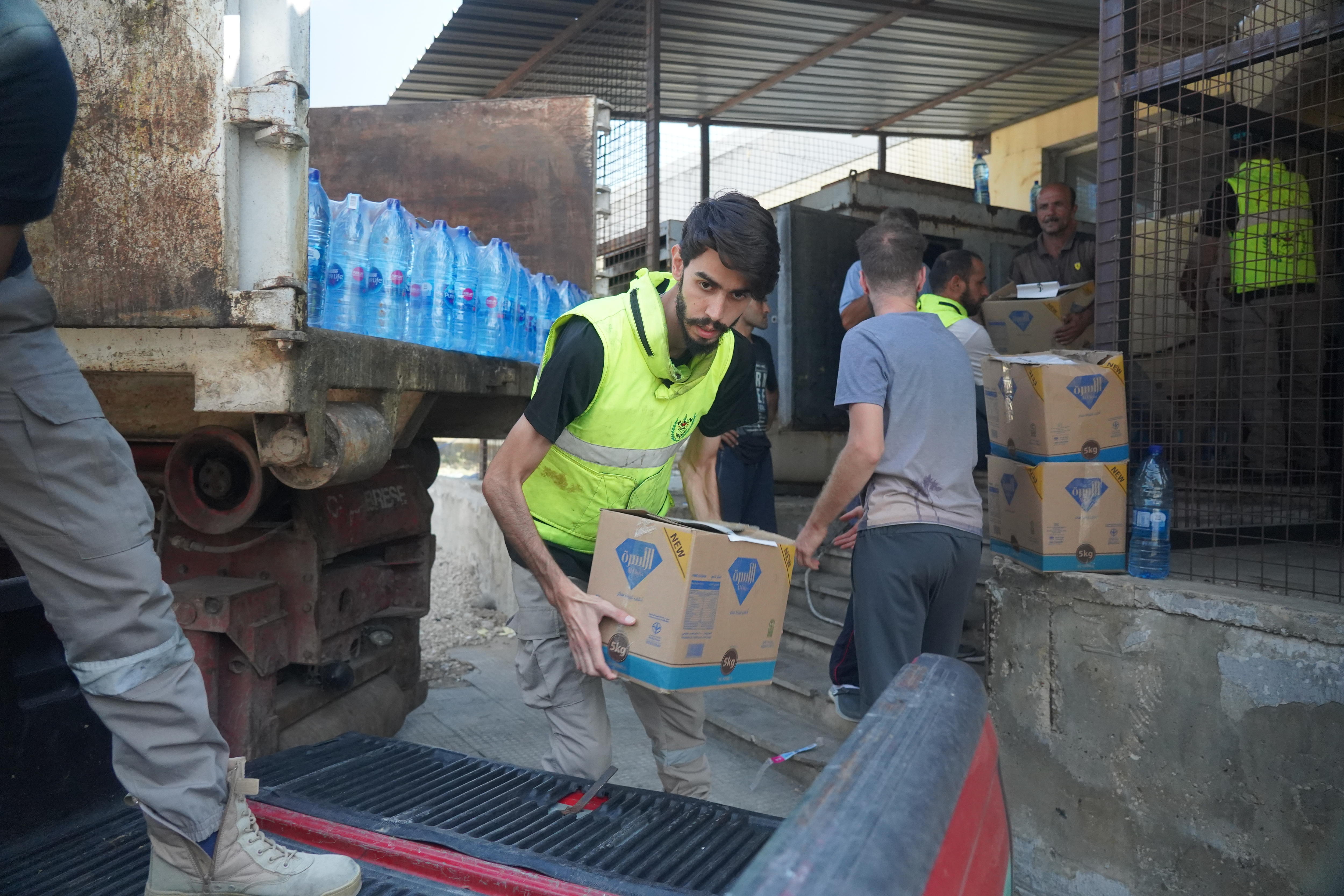 A man lifts a box onto a truck