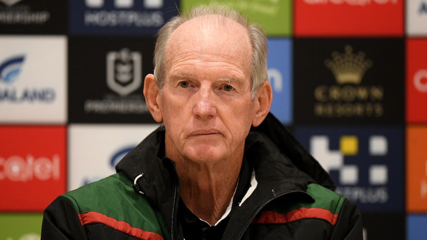 Wayne Bennett sits with a neutral expression on his face