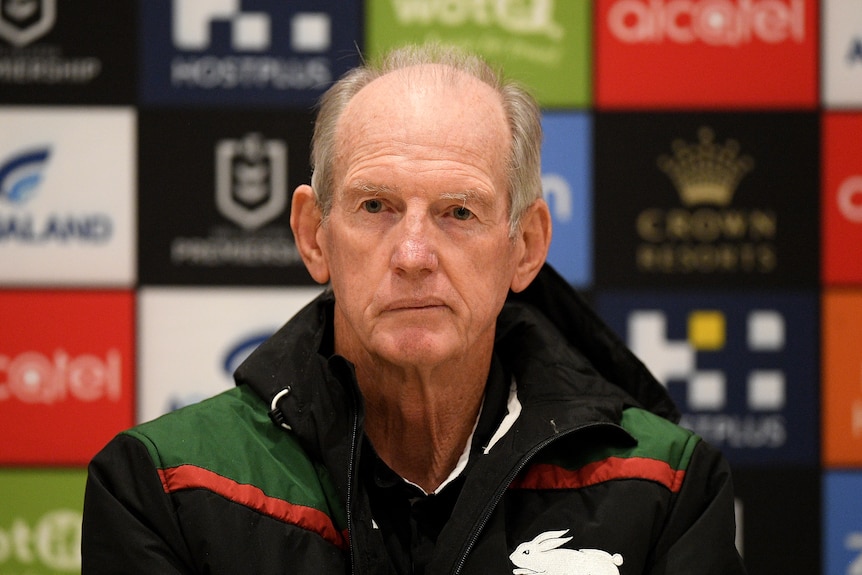 Wayne Bennett sits with a neutral expression on his face
