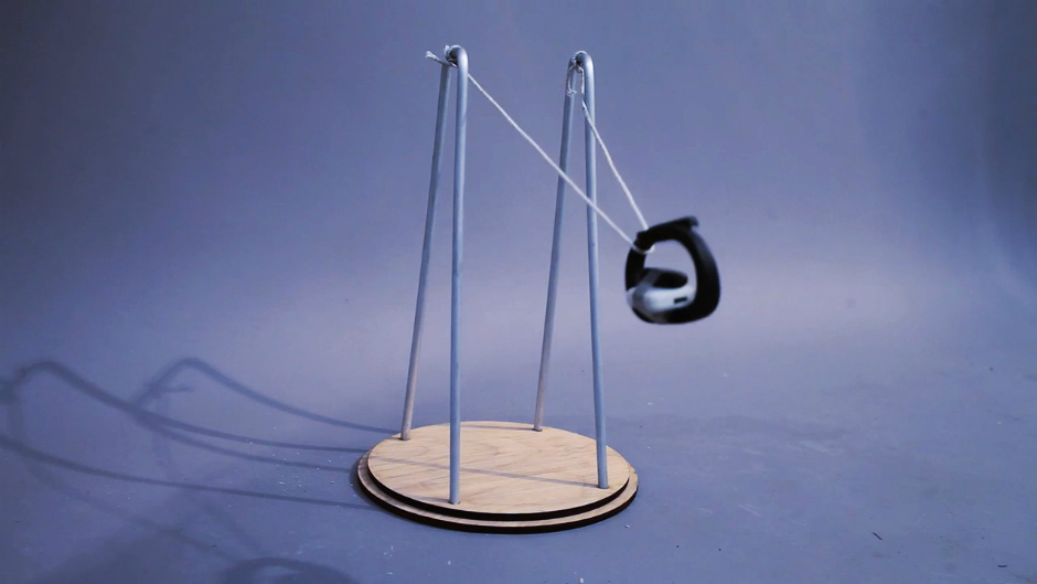 A fitness tracking device swinging like a pendulum.