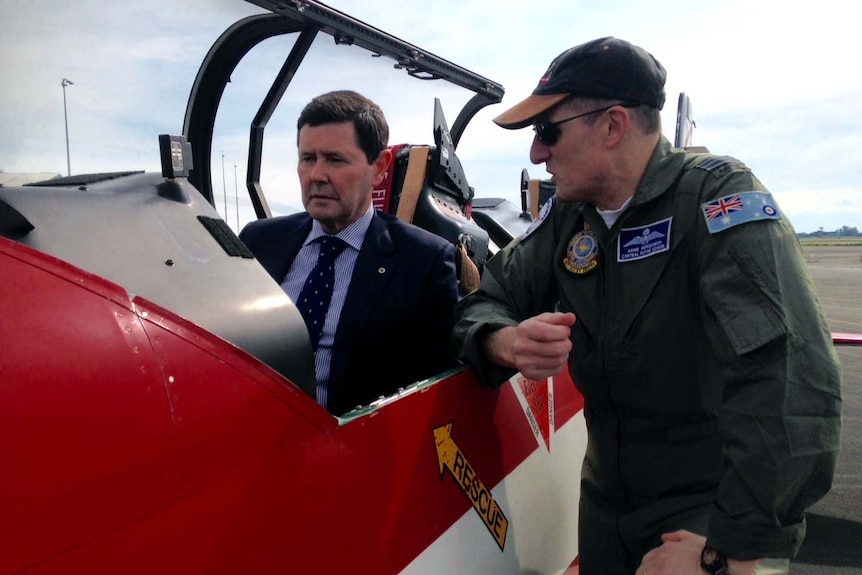 Defence Minister Kevin Andrews sitting in cockpit of RAAF training aircraft