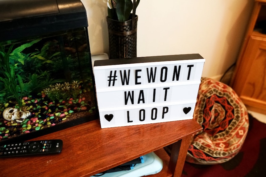 A sign in Shylie's living room reads #WeWon'tWait