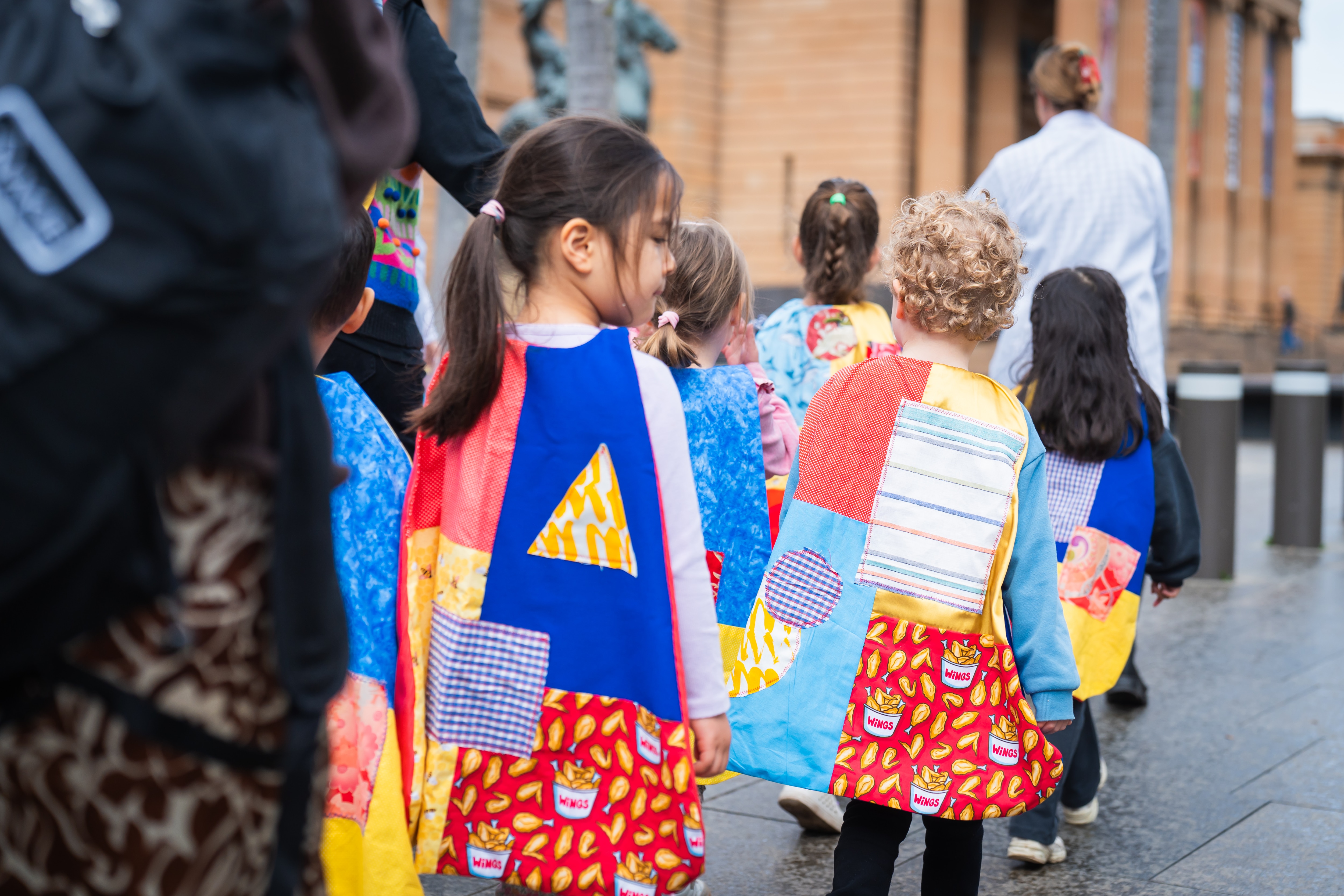 preschool students at Art Gallery of NSW wearing super hereo capes and surrounded by art