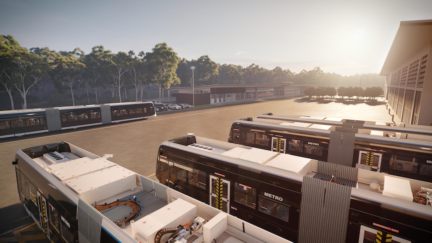 An image of several bi-articulated buses with a car park, a building, and trees in the background.