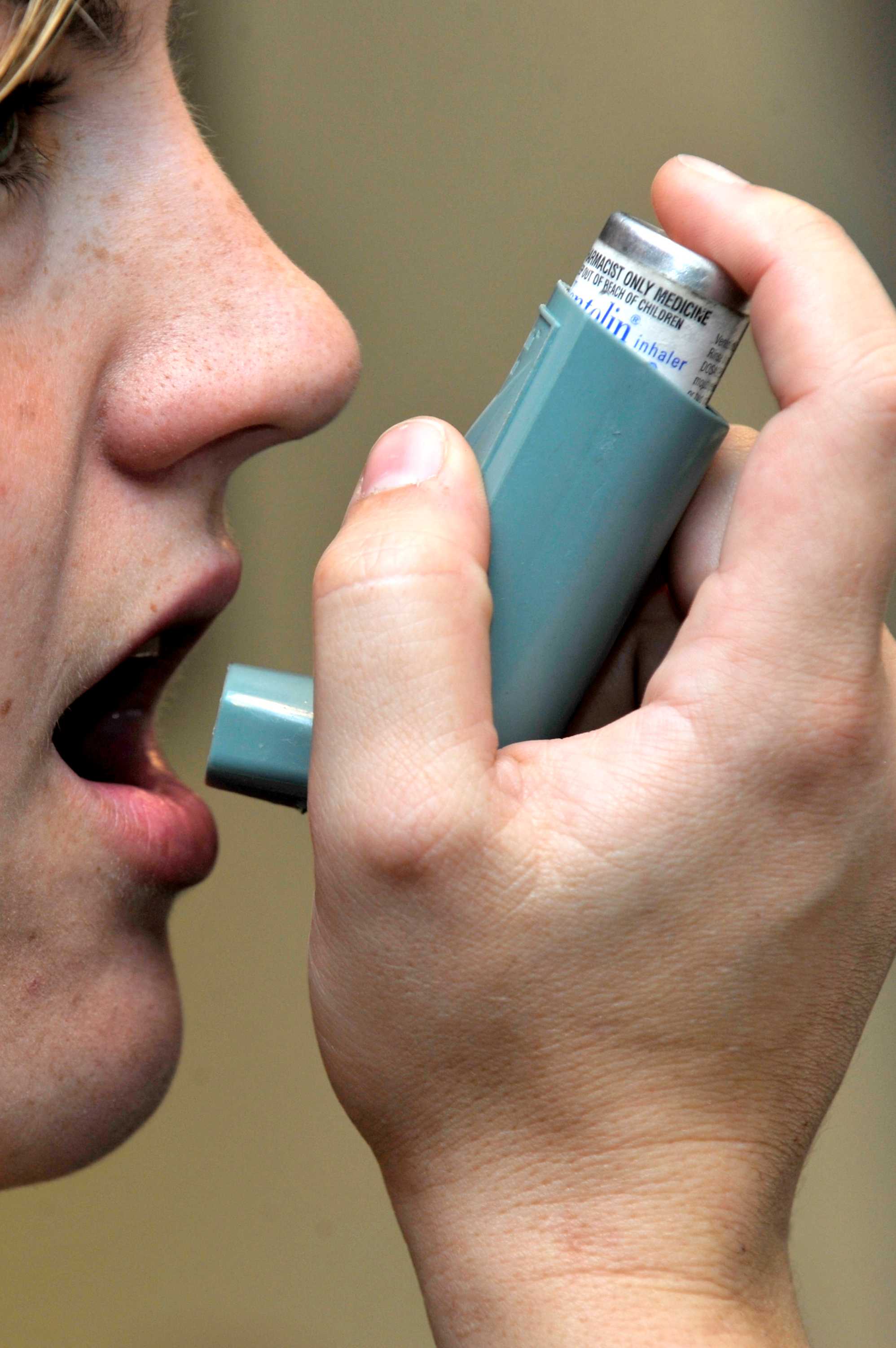 Woman using an asthma inhaler