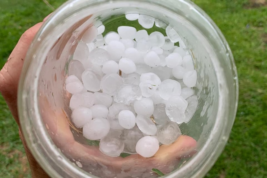 Hail stones collected in a glass container after storms sweep across Rockhampton