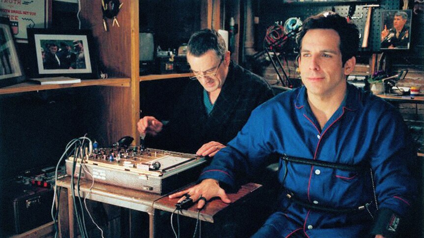 A still from the film Meet the Parents, showing Ben Stiller hooked up to a lie detector operated by Robert De Niro.