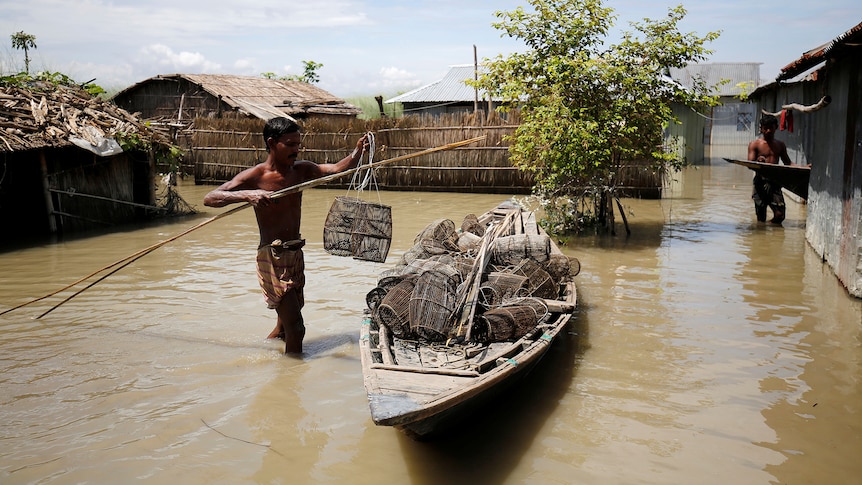 A fisherman prepares his fishing cages in his flooded premises in Gaibandha, Bangladesh.