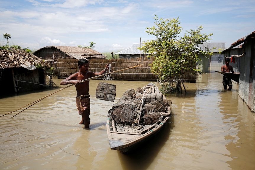 A fisherman prepares his fishing cages in his flooded premises in Gaibandha, Bangladesh.