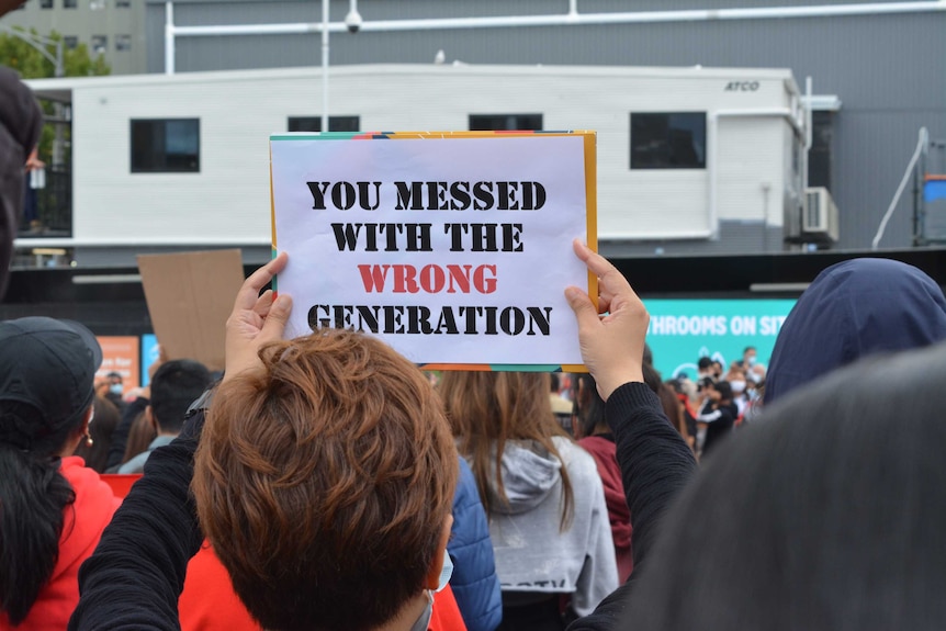 A protester holds a sign reading: 'You messed with the wrong generation' in Melbourne at a protest for Myanmar.