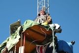 Cooma grazier Peter Spencer chained to a wind mast 18 metres above the ground