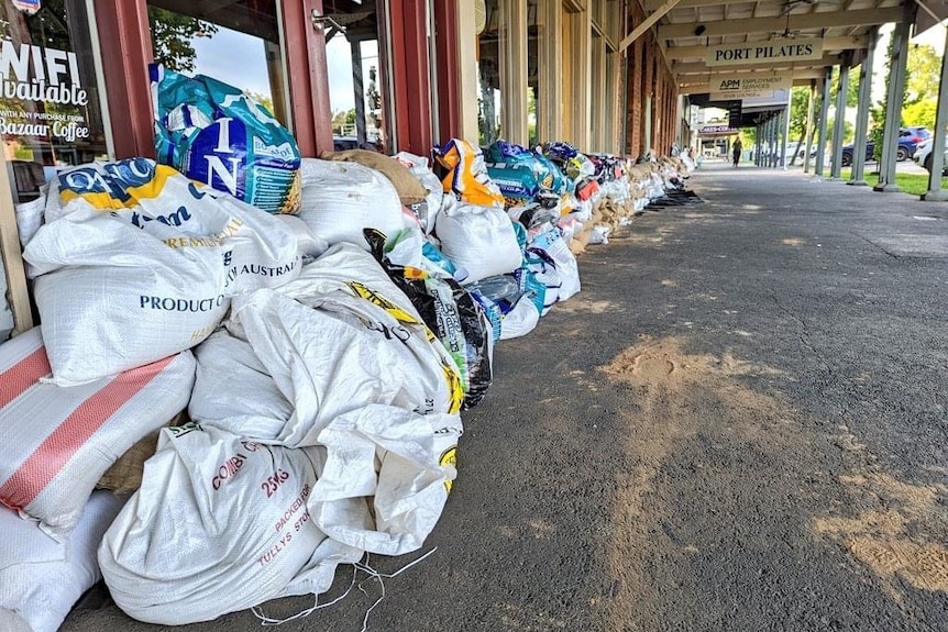 A country street lined with sandbags.