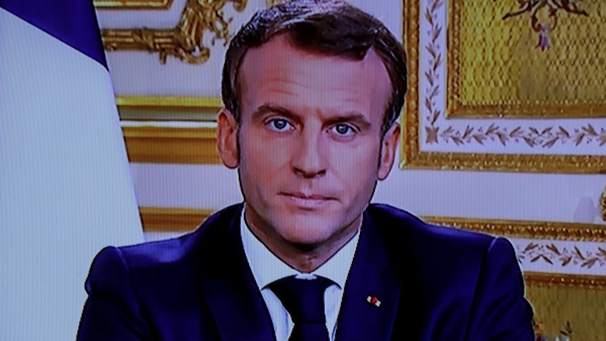 A photo of French President Macron during a TV address
