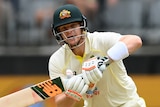 Australia batter Steve Smith plays a shot and sets off to run in a Test against West Indies.