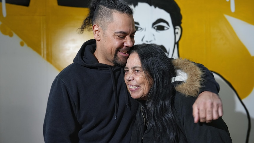 Carl King and his mother embrace.