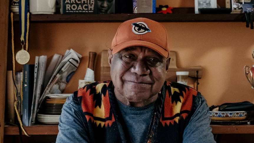 Archie Roach sitting at his kitchen table.
