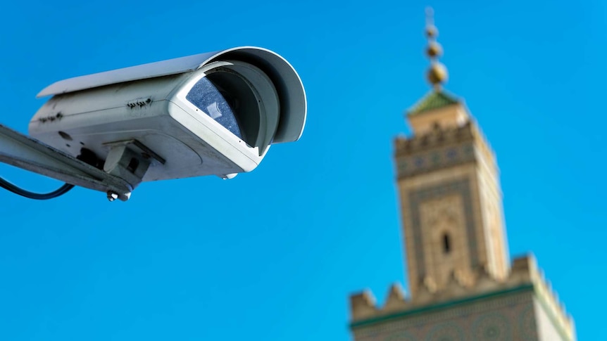 large security camera in front of mosque against blue sky background