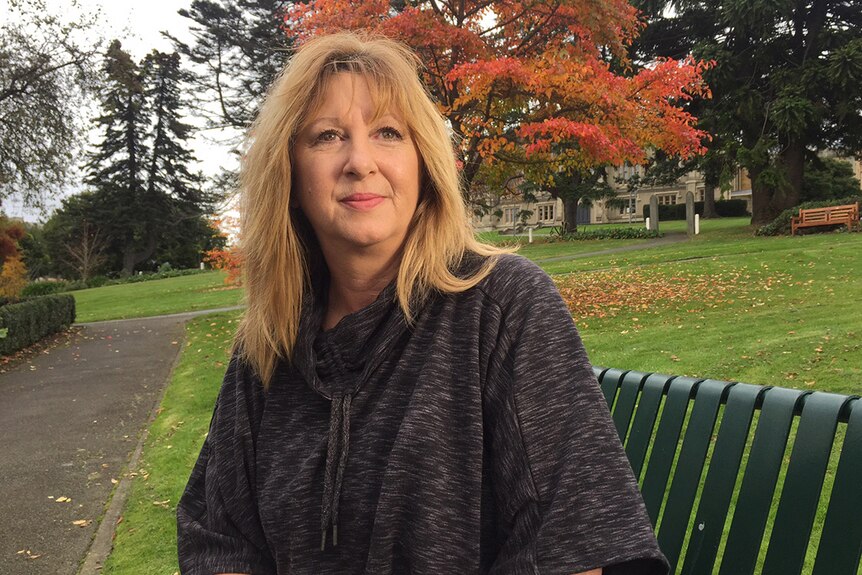 Denise McLean sitting on a park bench in Hobart.