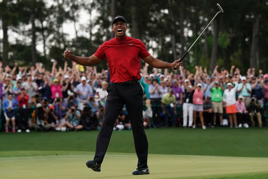 Tiger Woods punches the air in triumph after winning the Masters.