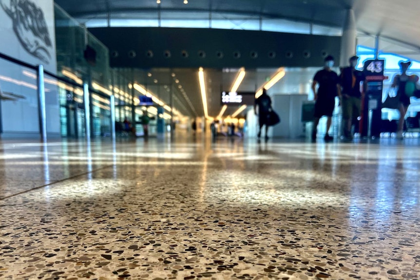 Floor level shot of a nearly empty airport terminal.