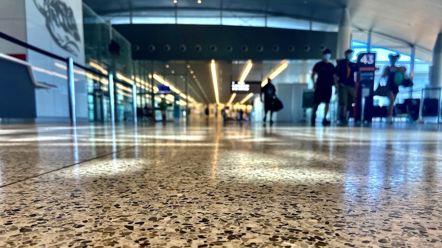 Floor level shot of a nearly empty airport terminal.