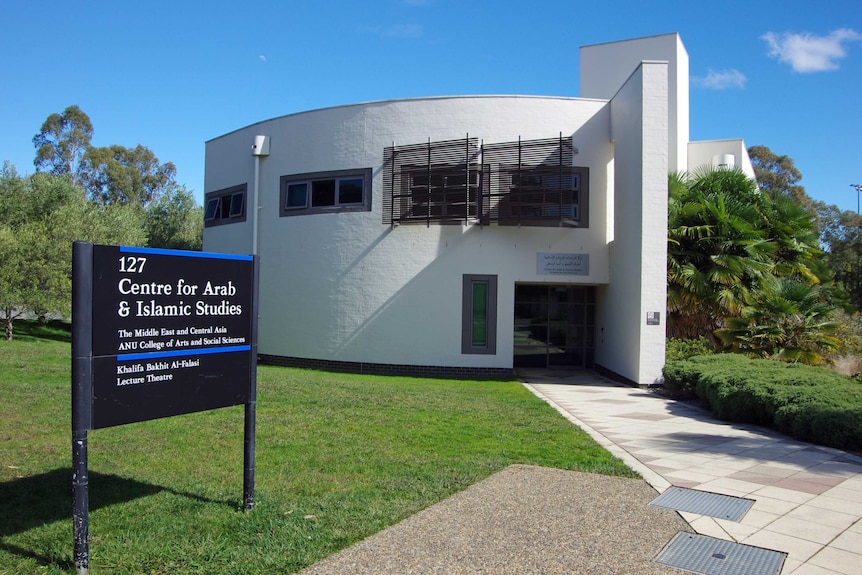 Exterior of circular white building, with sign 'Centre for Arab and Islamic Studies'