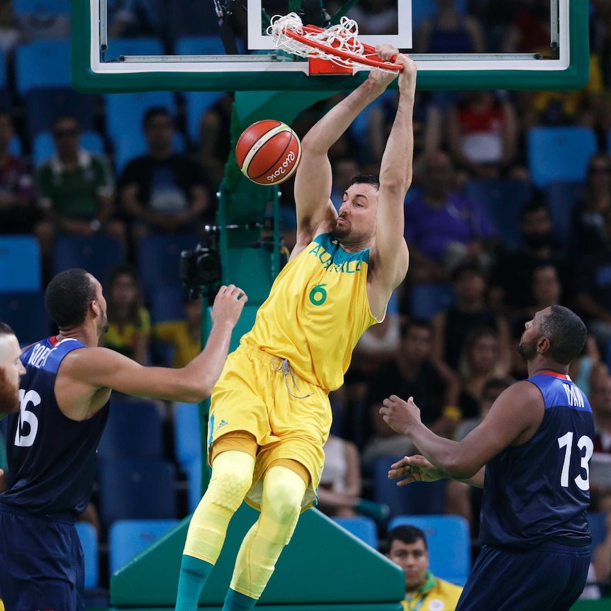 Australia's Andrew Bogut (6) dunks the ball over France's Rudy Gobert, and Boris Diaw at the 2016 Olympics.