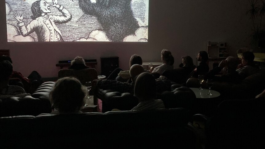 A group of cinema lovers sitting down to watch a film at a Derwent Valley Arts Film Society movie night.