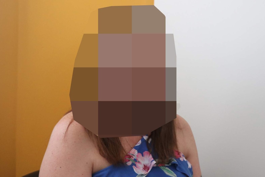 A woman whose face has been heavily pixellated