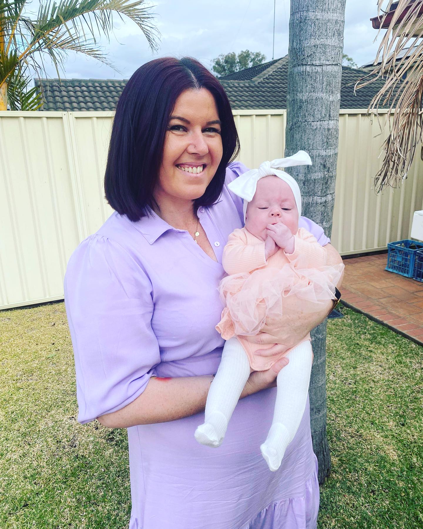 Sian Goodsell smiles while holding her daughter, Matilda, in her arms.