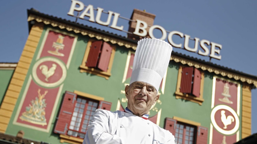French Chef Paul Bocuse poses outside his famed Michelin three-star restaurant L'Auberge du Pont de Collonges.