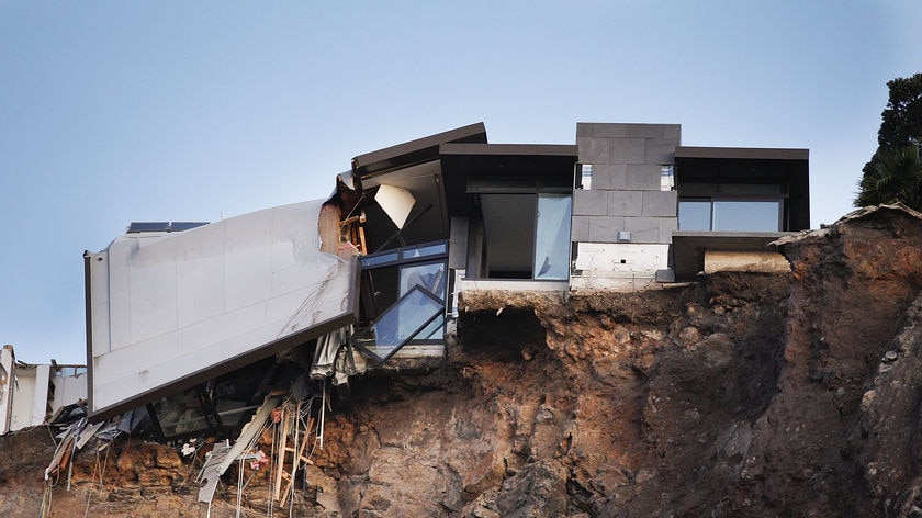 Quake-damaged home hangs from a cliff in Christchurch