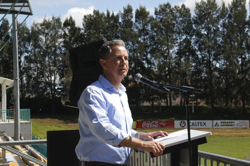 Jeremy Hanson speaks at a podium.