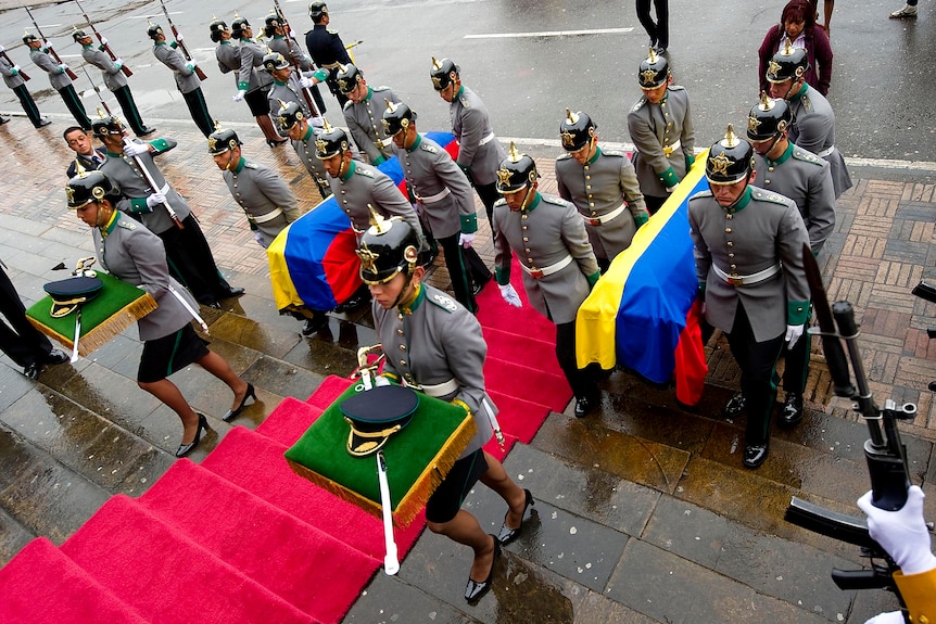 The caskets of four hostages receive military honours during their funeral in Bogota, Colombia.