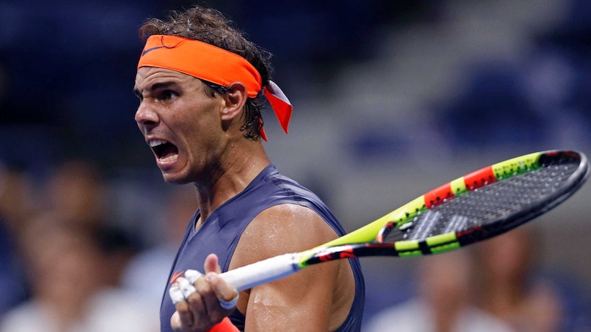 Rafael Nadal raises his racquet and reacts during his fourth-round match against Dominic Thiem at the US Open.