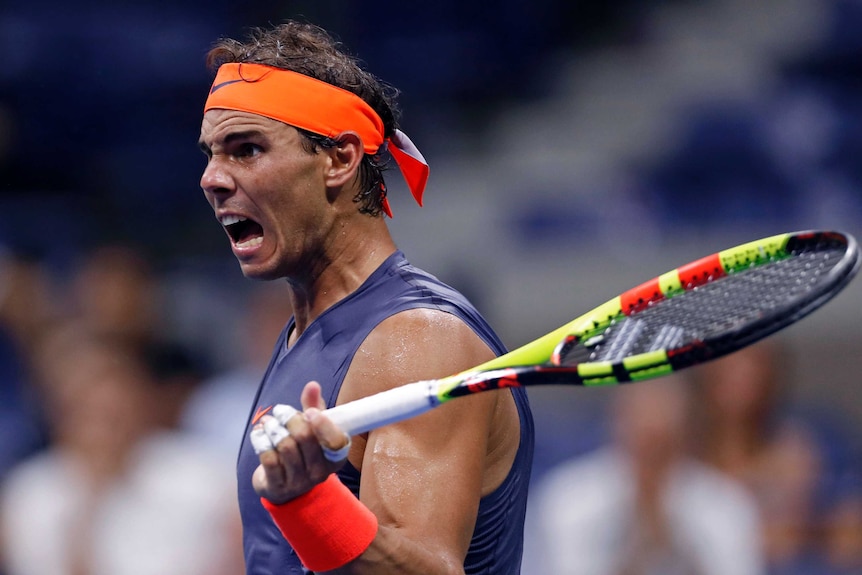 Rafael Nadal raises his racquet and reacts during his fourth-round match against Dominic Thiem at the US Open.