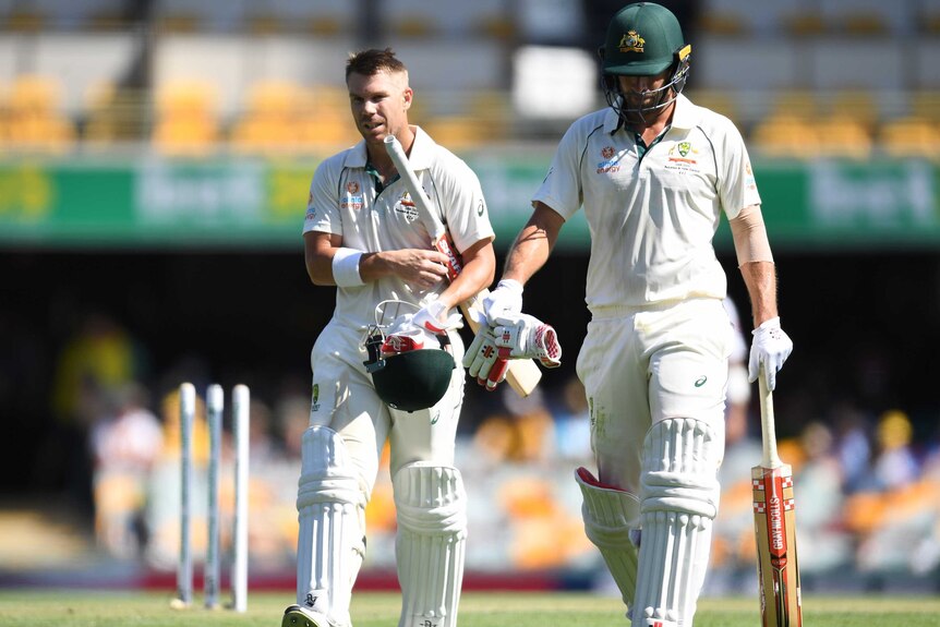 Two Australian batsmen walk off the Gabba together in a Test match against Pakistan.